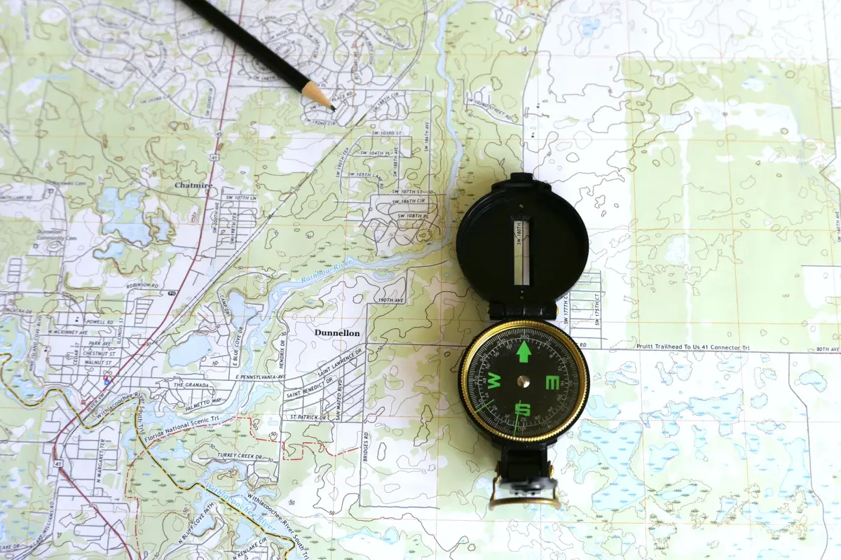 A detailed topographic map of Dunnellon, Florida with a compass and pencil.