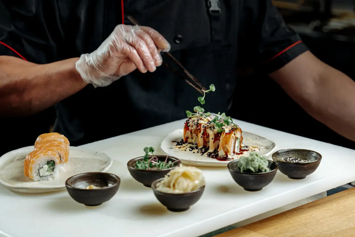 Chef crafting sushi with precision, showcasing gourmet elegance in a modern restaurant setting.