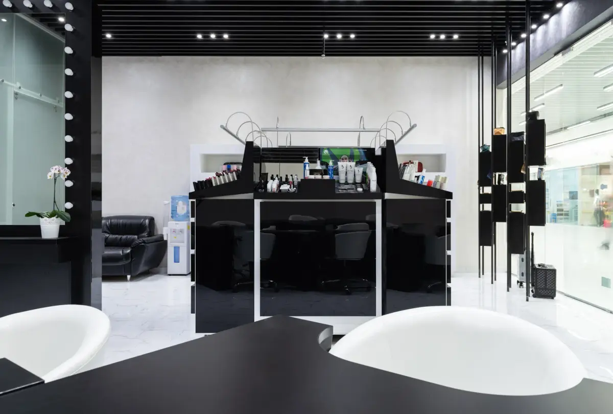 Chic modern beauty salon with black and white decor, offering a luxury experience.